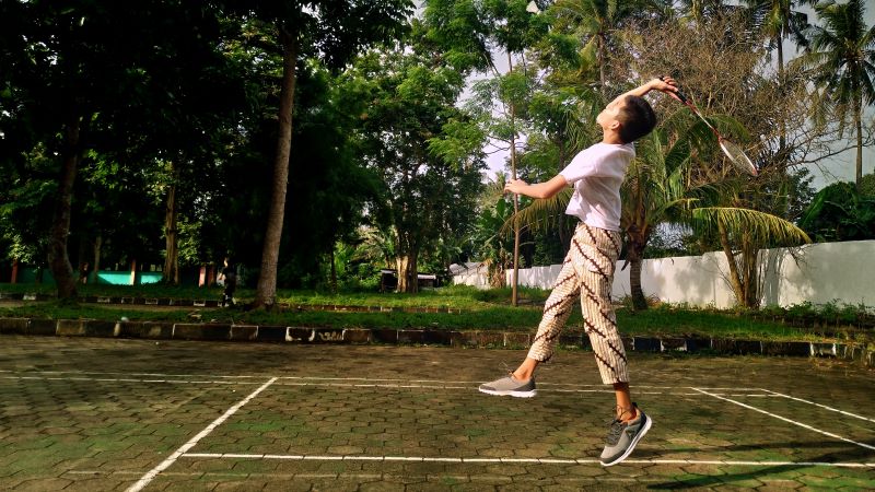 Badminton - chłopiec grający chłopiec grający w badmintona na dworze